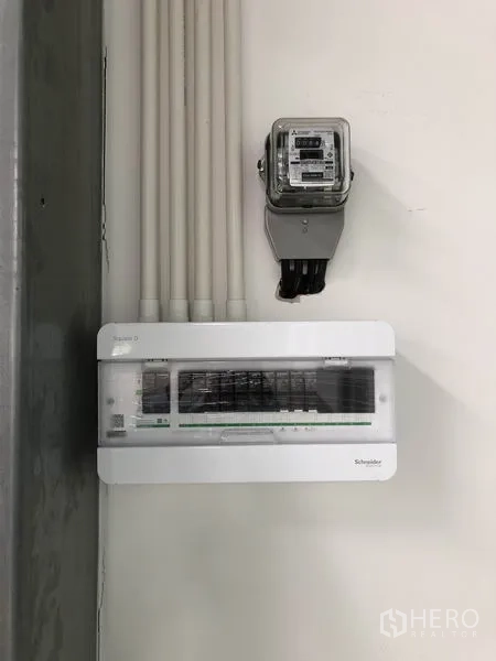 Warehouse for rent in Bang Yai, Nonthaburi - Close‑up of electrical meter and Schneider distribution panel mounted on a wall.