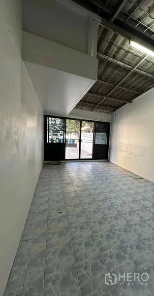 Home Office for rent in Din Daeng, Bangkok - Ground-floor room with tiled floor and black-framed sliding glass doors, ideal for a storefront or reception.