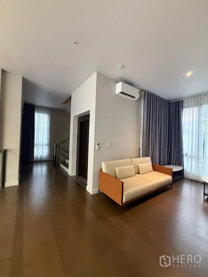 Detached House for rent in Saphan Sung, Bangkok - Upper-floor family lounge with sofa, stairway and sheer-draped windows.