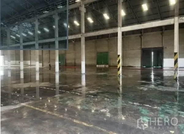 Warehouse for rent in Mueang Pathum Thani, Pathum Thani - Industrial interior showing polished concrete floor, structural columns, and safety-striped pillars.