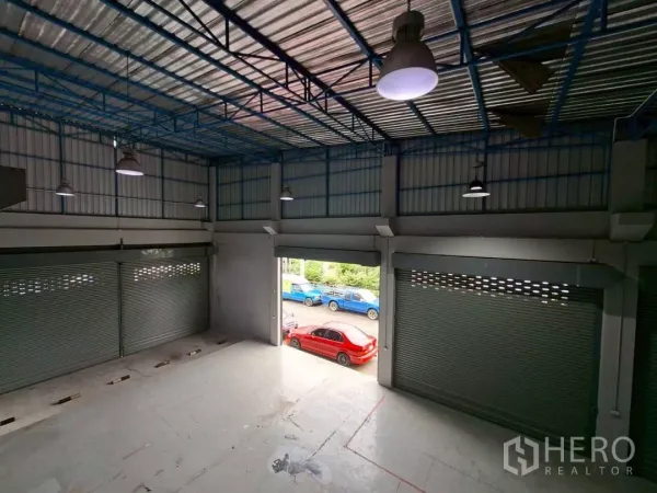 Warehouse for rent in Suan Luang, Bangkok - Open loading bay with roller doors, high-bay lights and direct street access.