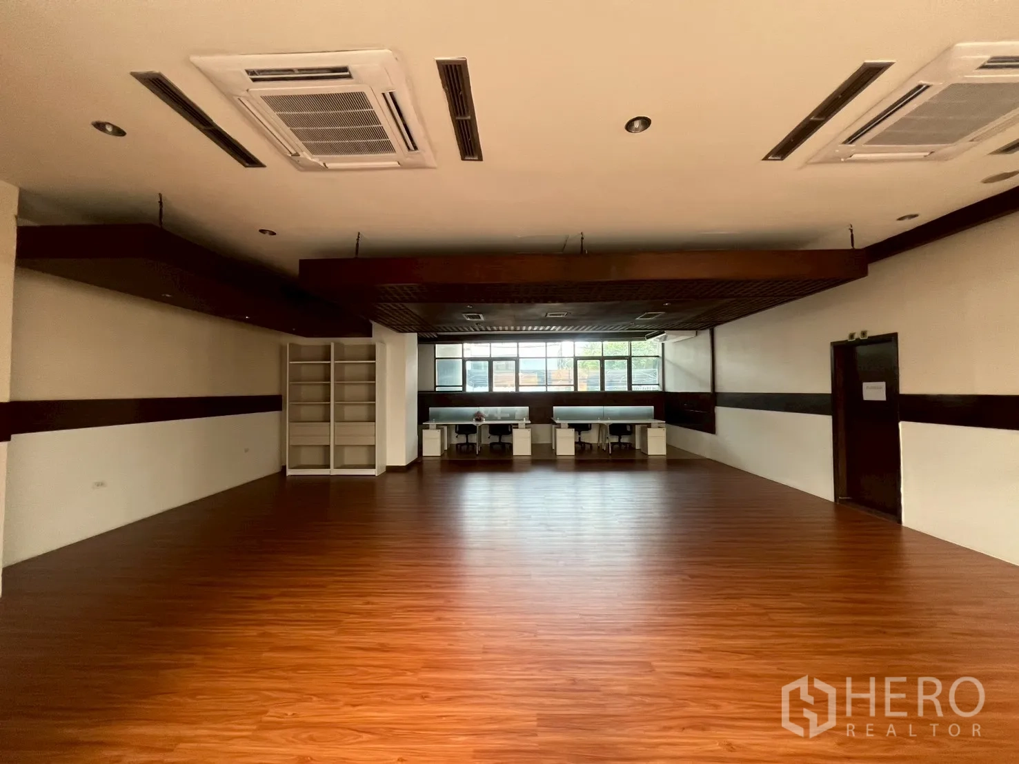 Retail Space for rent - Wide showroom space with cassette air-con units and warm wood floors.