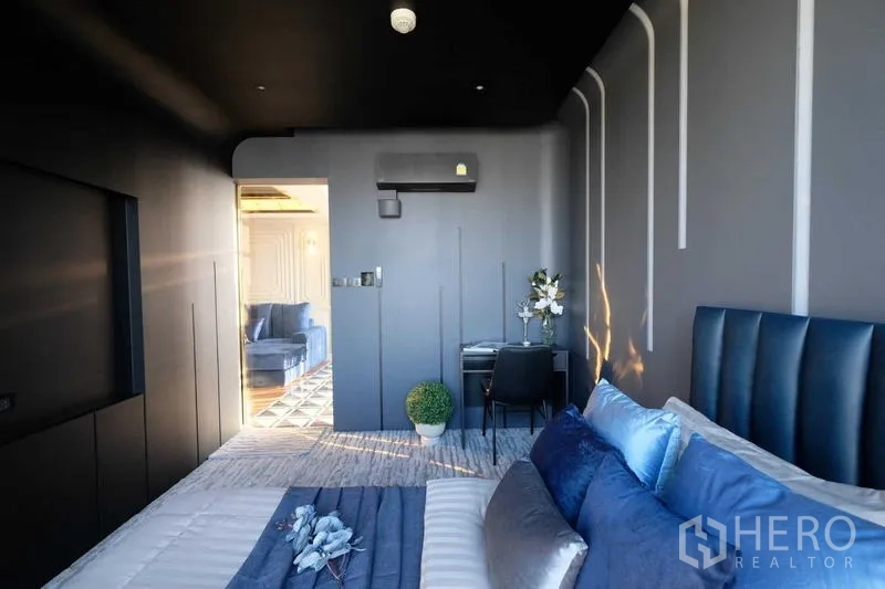 Condominium for sale - Bedroom view toward the living area with study corner and soft carpeting.
