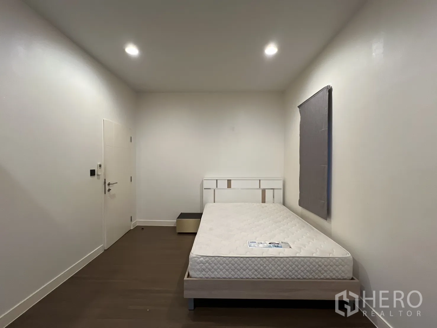 Detached House for rent or sale in Bang Kapi, Bangkok - Additional bedroom with bed frame and plain wall.