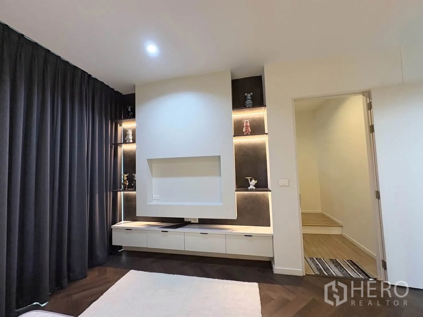 独栋房屋 for rent in Saphan Sung, Bangkok - 带灯带的内嵌展示架与电视墙旁的通道。