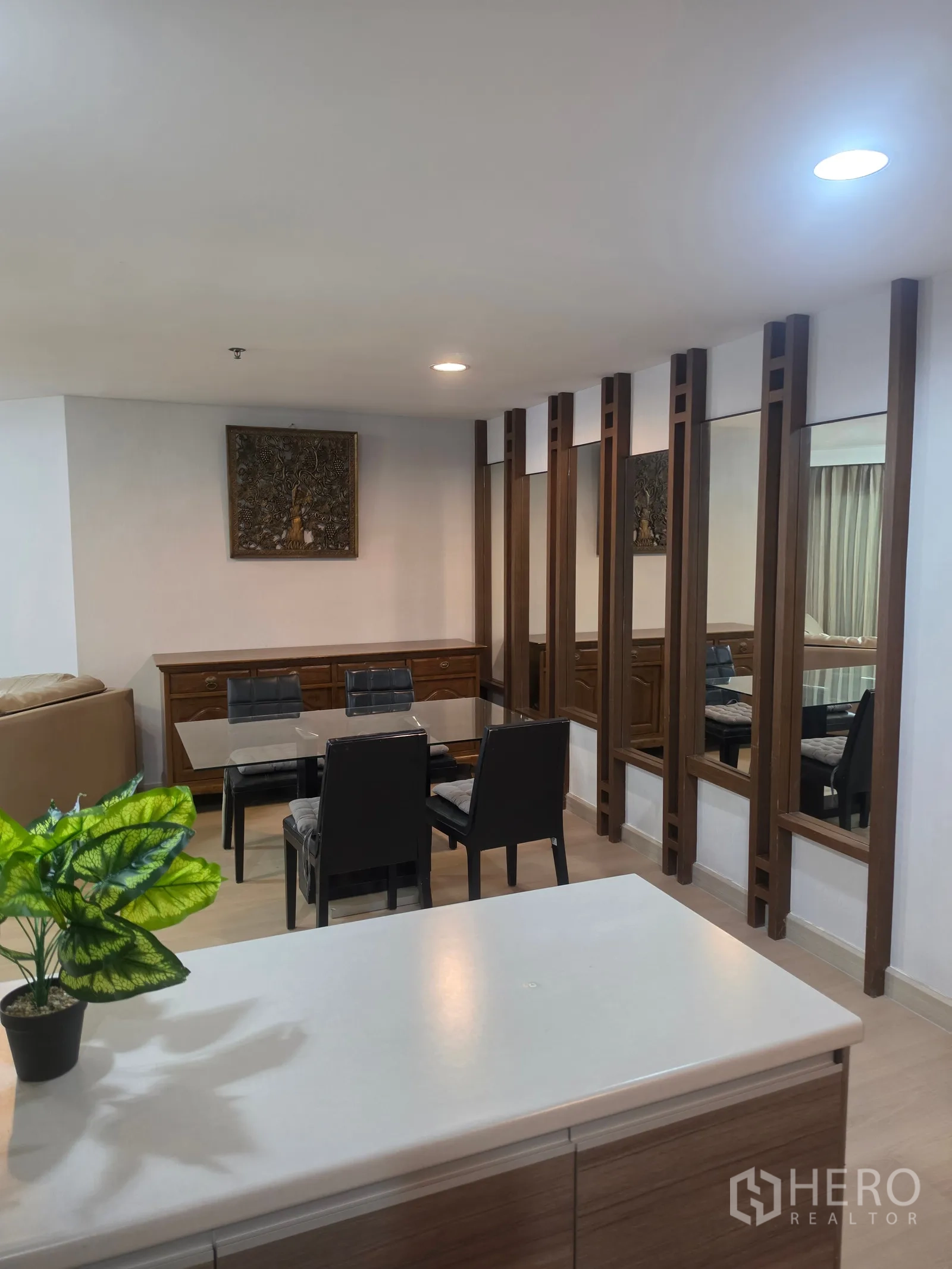 Condominium for rent in Huai Khwang, Bangkok - Wider dining view with mirrored panels and light wood flooring.