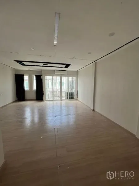 Home Office for rent - Large upper-floor workspace with recessed ceiling detail and balcony doors providing natural light.