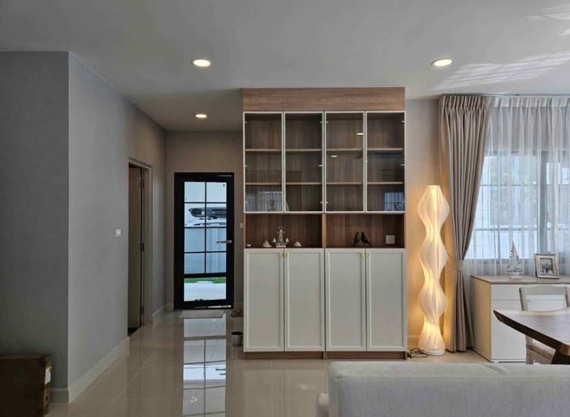 Detached House for rent in Bang Phli, Samut Prakan - Built‑in storage cabinet beside a side entry door and study nook with natural light.