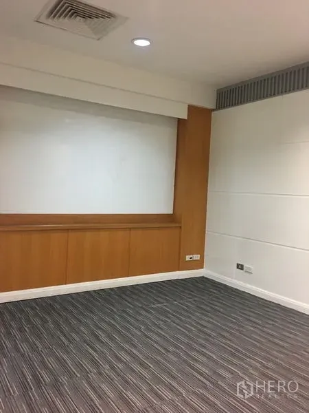 Office Space for rent in Chatuchak, Bangkok - Private office with built-in wood cabinetry, whiteboard wall, and striped carpet.