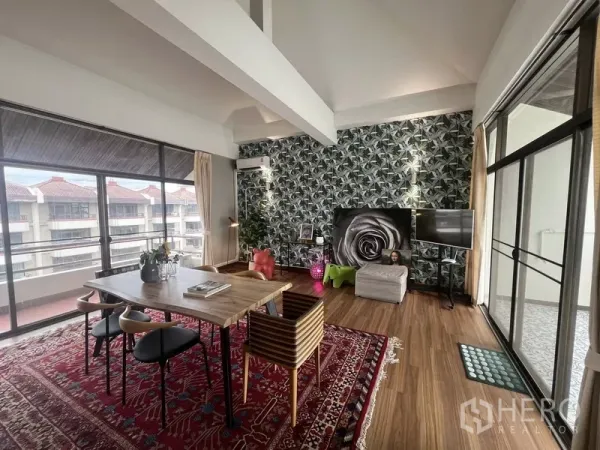 Townhouse for rent or sale in Suan Luang, Bangkok - Bright multipurpose room with feature wallpaper, wood floors and balcony views.