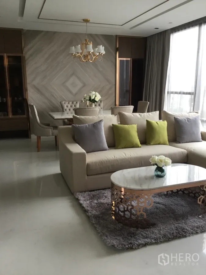 Condominium for rent in Sathon, Bangkok - Elegant living and dining room with chandelier, marble coffee table, plush sofa and floor-to-ceiling windows in a Sathon condo.