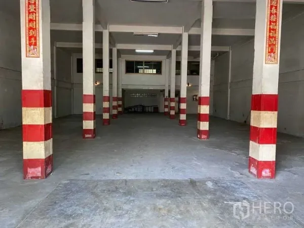 Warehouse for rent in Phasi Charoen, Bangkok - Open-plan warehouse interior with column grid, concrete floor and ceiling lights.