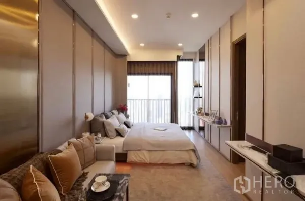 คอนโด ขายในWatthana, Bangkok - ห้องนอนมาสเตอร์กว้าง พร้อมมุมโซฟาพักผ่อน ไฟสวย และประตูหน้าต่างออกระเบียง