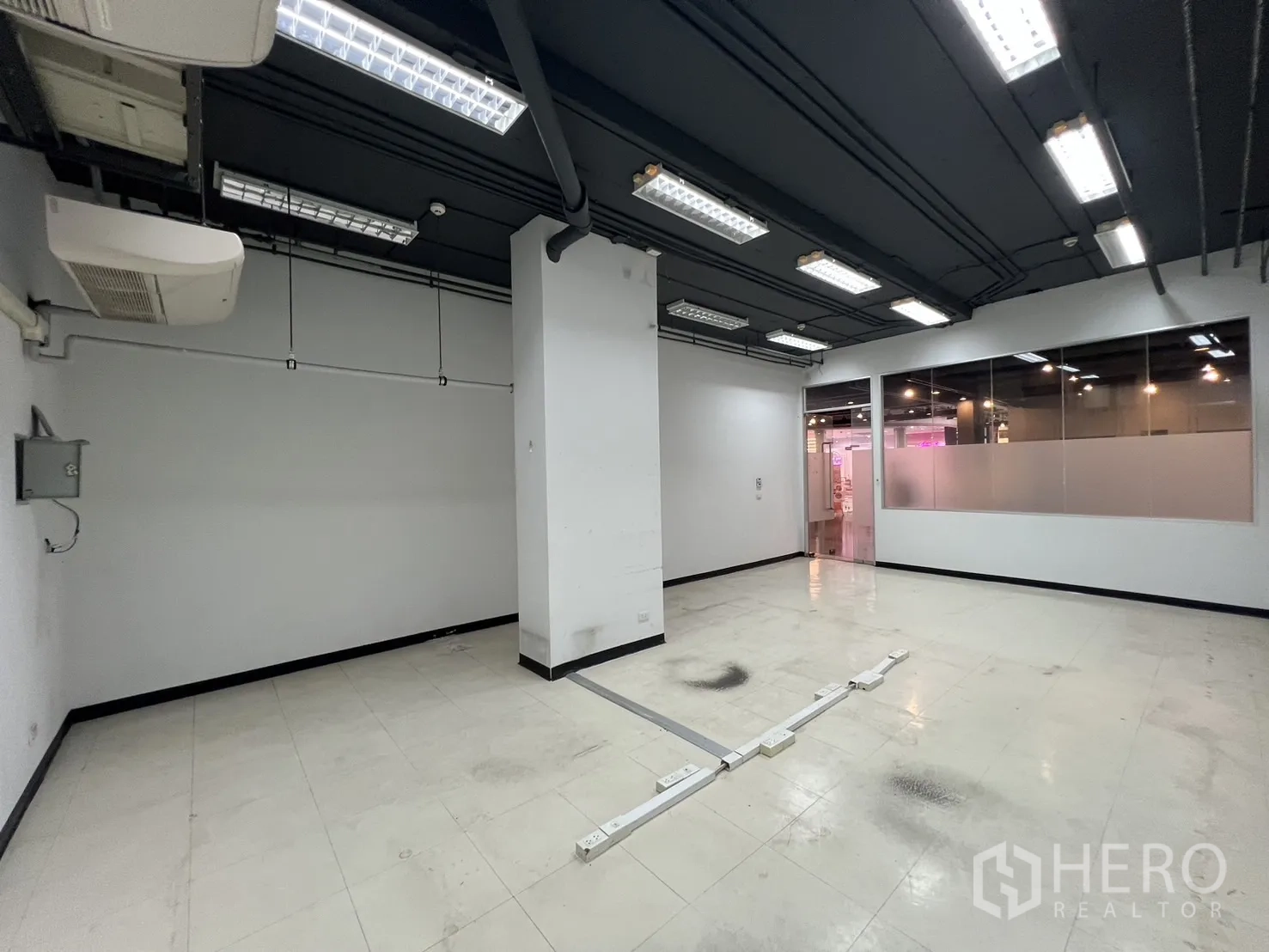 Retail Space for rent - Bright retail space with fluorescent lights, glass partition and floor power trunking.