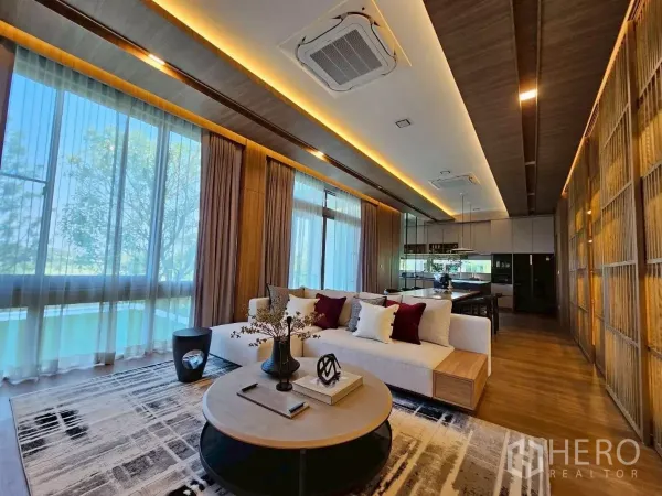 Detached House for rent in Saphan Sung, Bangkok - Bright lounge with floor-to-ceiling windows, sectional sofa, and dining area.