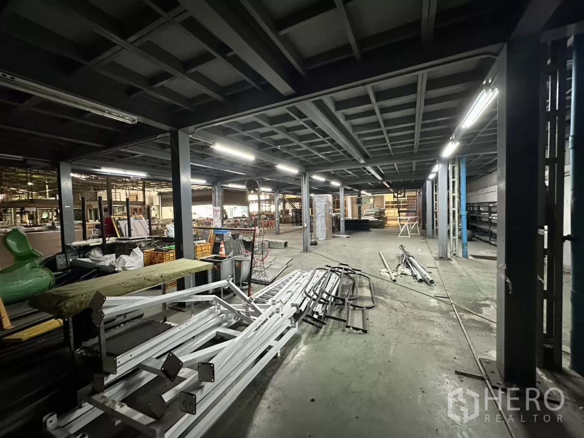 Warehouse for rent in Yan Nawa, Bangkok - Under‑mezzanine workspace with steel columns, lighting and materials.