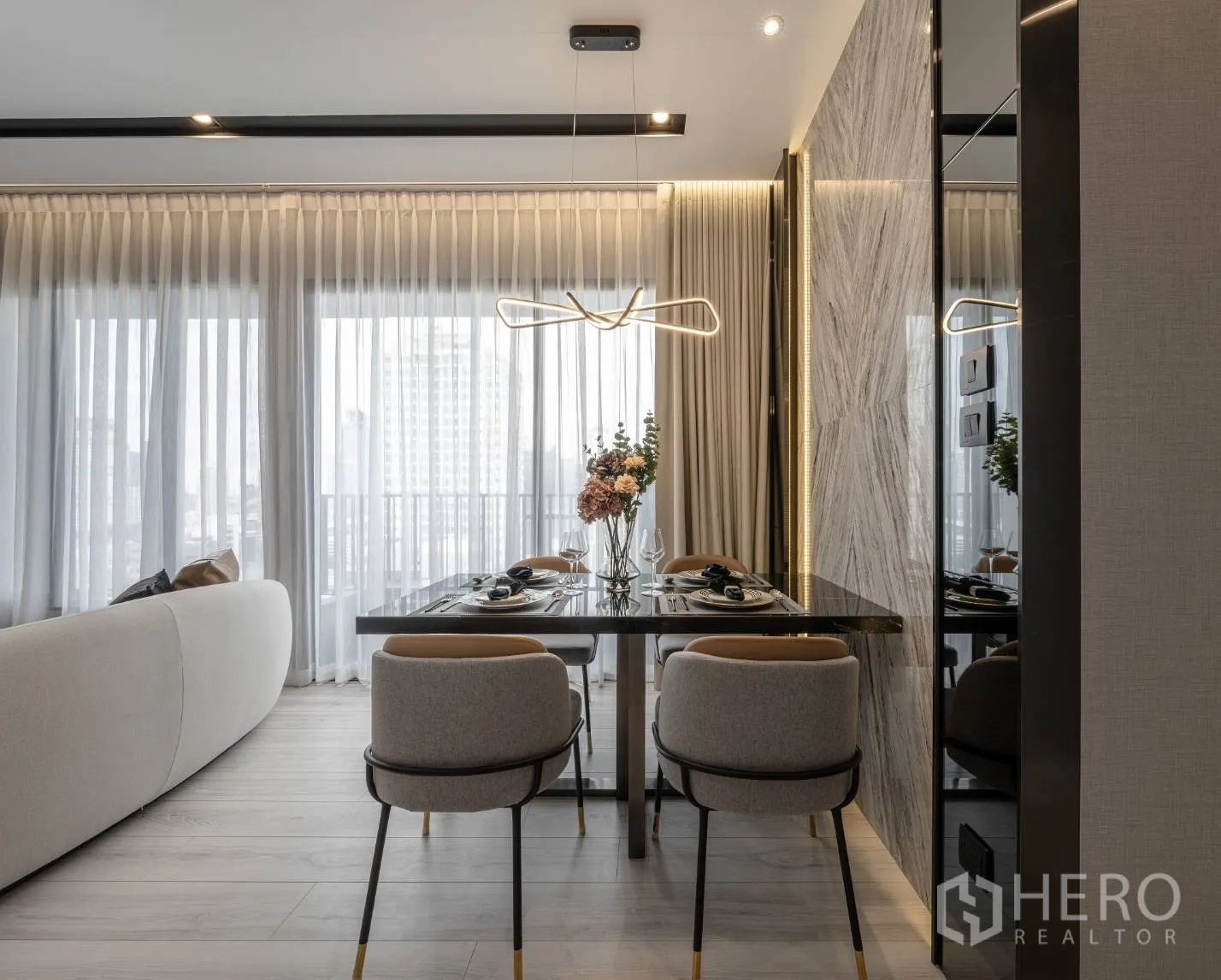 公寓 出售在Ratchathewi, Bangkok - 四人餐桌靠近阳台窗，搭配艺术吊灯。