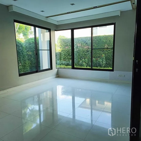 独立式住宅 出租或出售在Mueang Nonthaburi, Nonthaburi - 转角房大窗户，眺望私密绿篱景致。