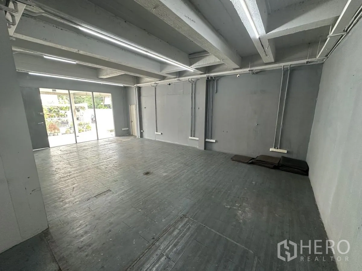 Home Office for rent in Chatuchak, Bangkok - Ground-floor open space with sliding glass doors and strip lighting.