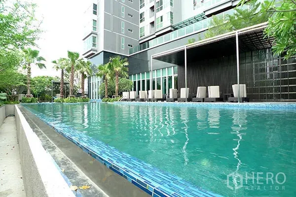 คอนโด ให้เช่าในRatchathewi, Bangkok - สระว่ายน้ำกลางแจ้งพร้อมเตียงอาบแดดและสวนของคอนโดมิเนียม