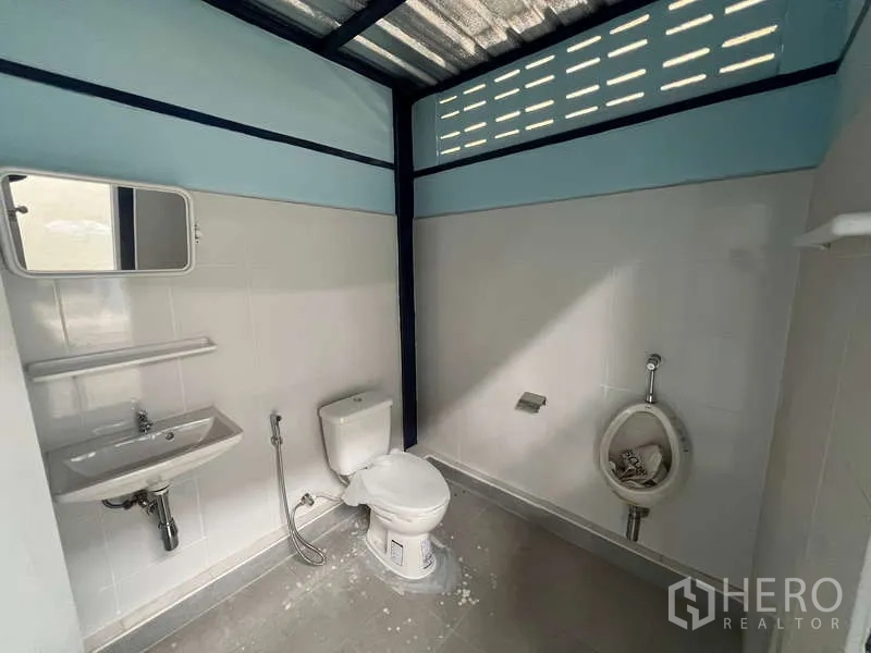 Warehouse for rent in Lat Krabang, Bangkok - Clean staff restroom inside the warehouse with sink, toilet and urinal, finished in white tiles.