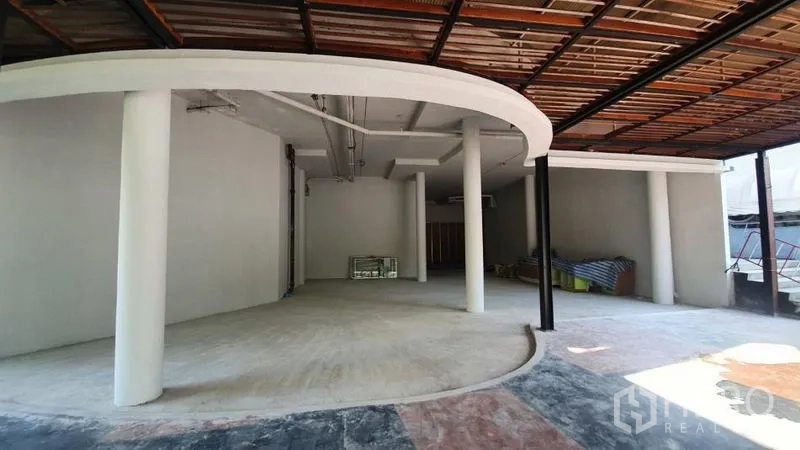 Retail Space for rent in Khlong Toei, Bangkok - Curved facade connecting indoor space with a covered patio under a wood slat roof.