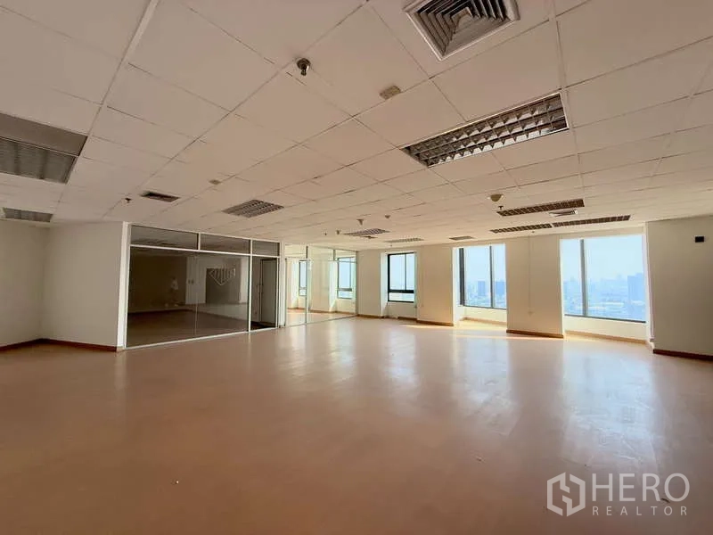 Office Space for rent in Chatuchak, Bangkok - Bright office area with glass partitions and panoramic windows overlooking the Bangkok skyline.