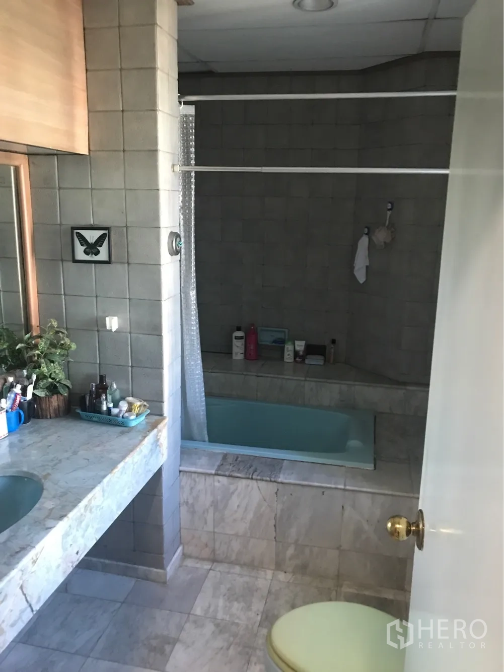 Condominium for rent or sale in Watthana, Bangkok - Bathroom featuring a marble vanity and a built-in soaking bathtub with tiled walls.
