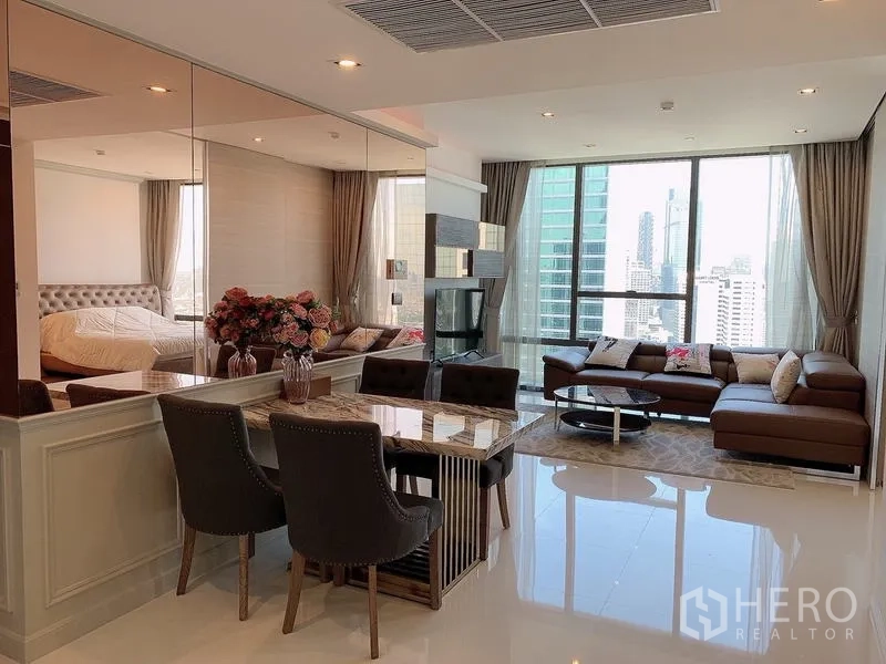 Condominium for sale - Open-plan living and dining with floor-to-ceiling windows and Sathorn skyline view.