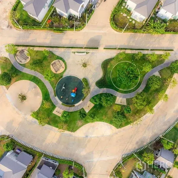 Detached House for sale in Lam Luk Ka, Pathum Thani - Aerial view of landscaped community park with playground and curving walking paths.