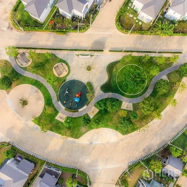 Detached House for sale in Lam Luk Ka, Pathum Thani - Aerial view of landscaped community park with playground and curving walking paths.