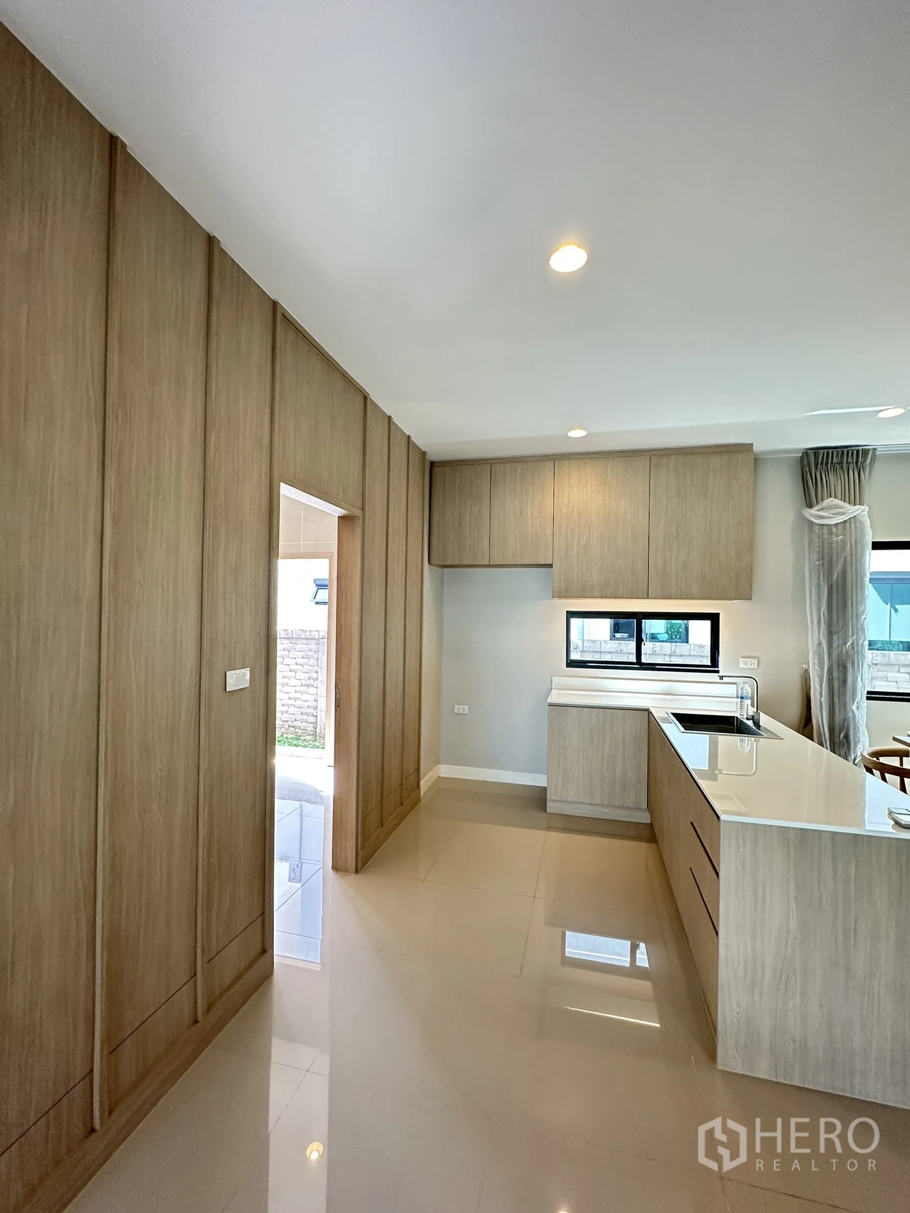 Detached House for sale in Lam Luk Ka, Pathum Thani - Western kitchen with island sink, built-in cabinets and a side window.