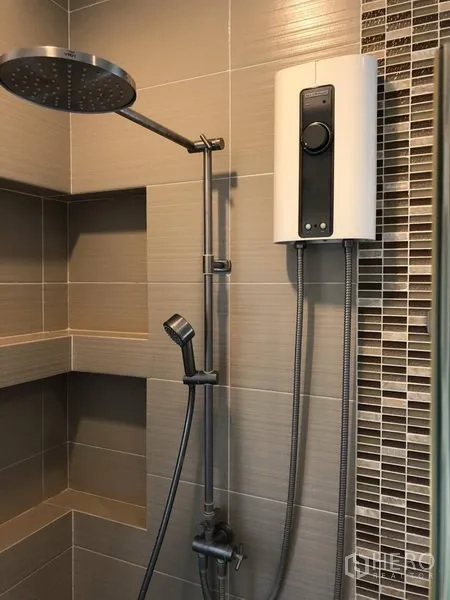 Detached House for rent in Saphan Sung, Bangkok - Bathroom with rain shower, handheld sprayer and water heater on neutral wall tiles.