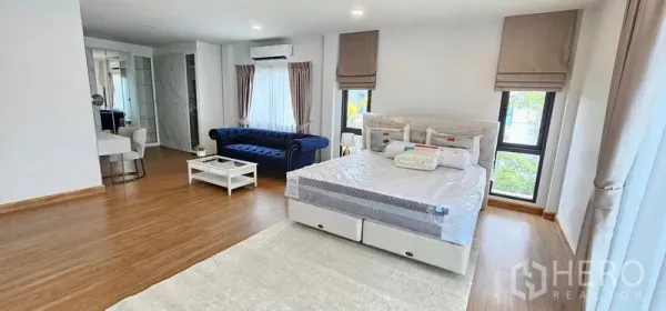 Detached House for rent in Bang Phli, Samut Prakan - Master suite showing seating area, rug and abundant natural light with a dressing corner nearby.