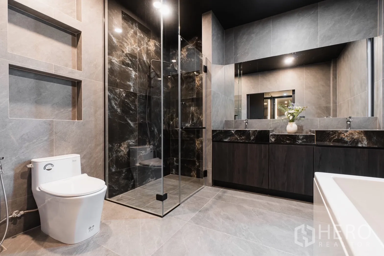 Detached House for rent or sale in Prawet, Bangkok - Bathroom with marble-look shower enclosure and twin sinks