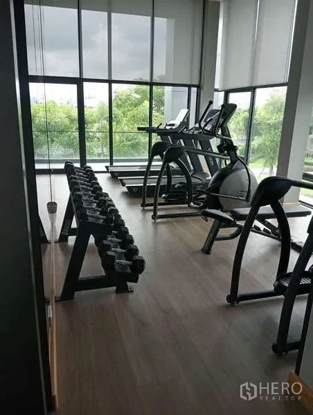 Detached House for rent in Bang Phli, Samut Prakan - Modern fitness room with treadmills, ellipticals and a rack of free weights.