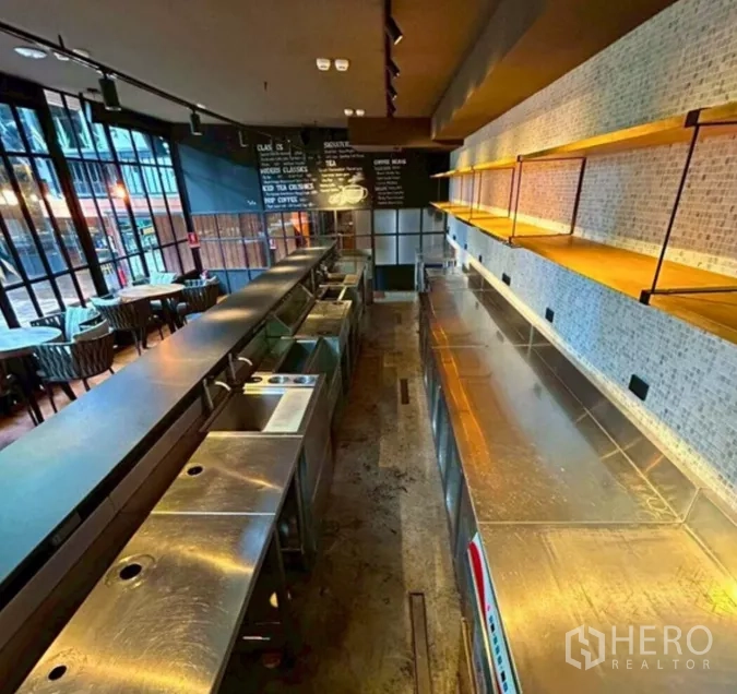 Retail Space for rent in Yan Nawa, Bangkok - Stainless steel bar and prep counters with open shelves and a menu board inside the fitted venue.