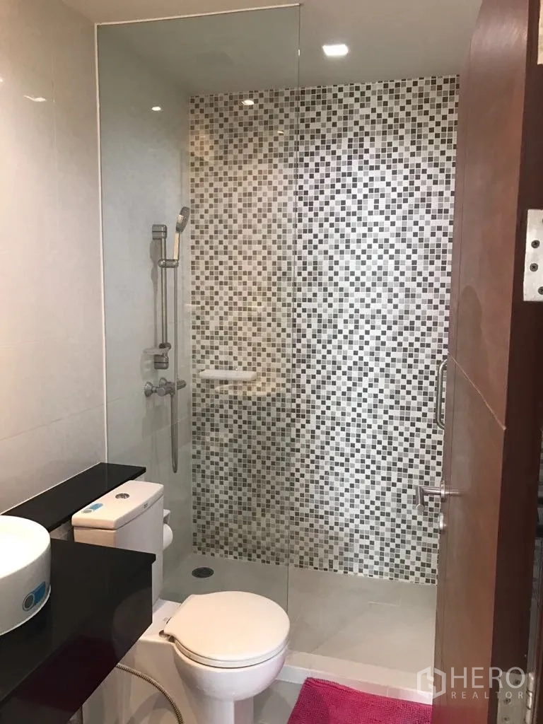 公寓 出租在Watthana, Bangkok - 第二浴室为步入式淋浴，马赛克墙面，配坐便和台上盆。