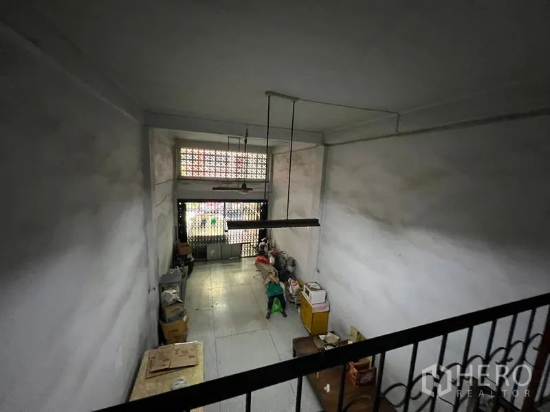 Shophouse for sale in Phra Khanong, Bangkok - Mezzanine viewpoint overlooking the double‑height ground floor and front gate.