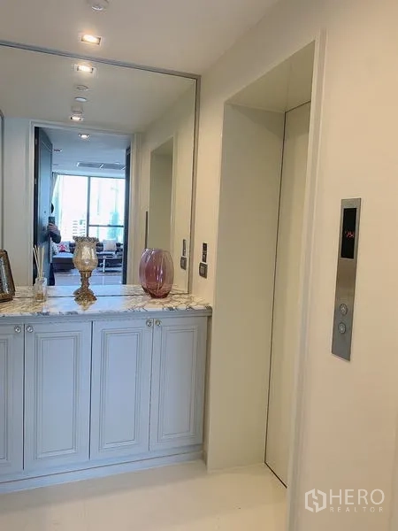 Condominium for sale - Private foyer with marble-topped cabinets and lift lobby access.