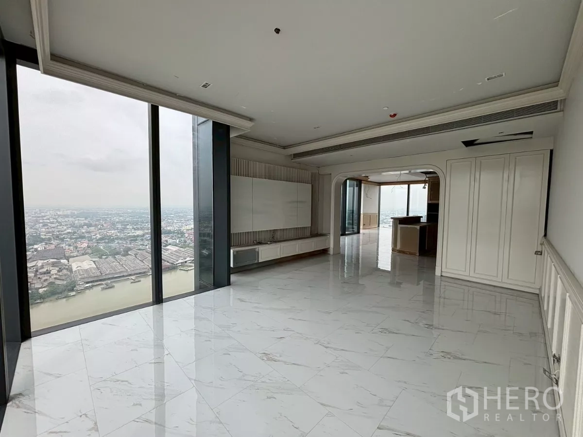 Condominium for sale in Bang Kho Laem, Bangkok - Duplex penthouse living room with marble floors, floor-to-ceiling windows and sweeping Chao Phraya River view.