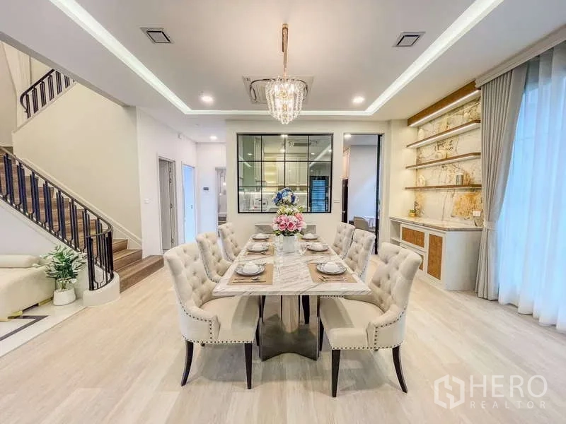 Detached House for rent in Saphan Sung, Bangkok - Formal dining room with marble table, tufted chairs and window to the kitchen.