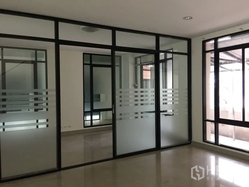 Office Space for rent in Bang Kho Laem, Bangkok - Meeting rooms with frosted glass sliding partitions and black frames.