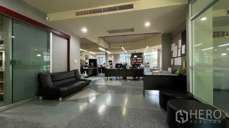 Warehouse for sale in Bangkok Yai, Bangkok - Modern office reception with glass partitions and open workspace beyond.
