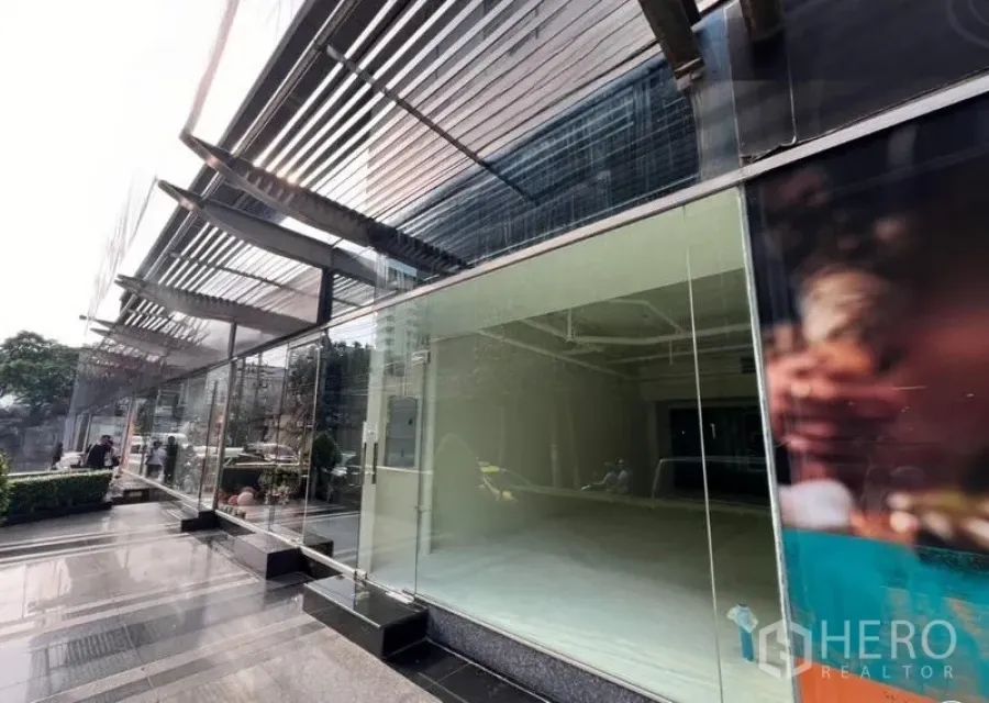 Retail Space for rent in Watthana, Bangkok - Exterior glass facade with metal sunshades and a polished plaza outside the retail space.