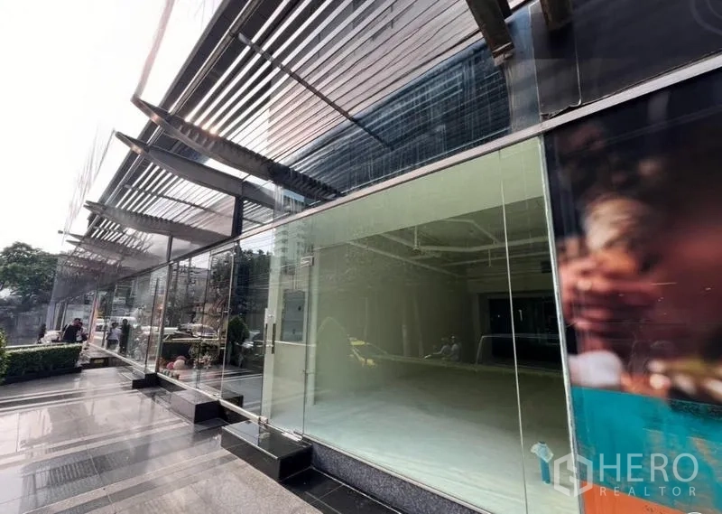 Retail Space for rent in Watthana, Bangkok - Exterior glass facade with metal sunshades and a polished plaza outside the retail space.