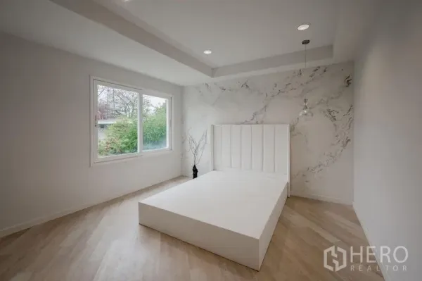Townhouse for sale - Bright bedroom featuring a large window, light wood floor and a minimalist white platform bed.