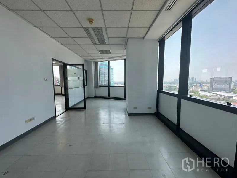 办公空间 出租在Khlong Toei, Bangkok - 采光充足的工作区，落地窗、连通门与天际线景致。