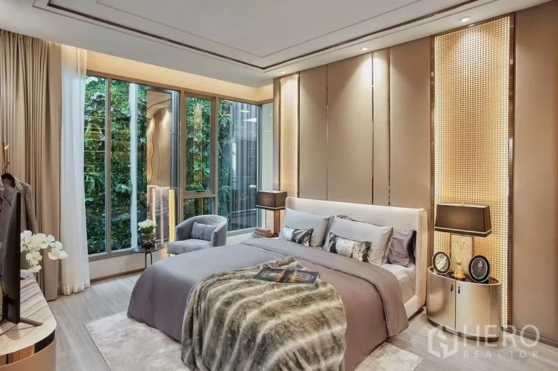 Condominium for sale in Bang Kho Laem, Bangkok - Bedroom with floor-to-ceiling windows and lush garden outlook, modern bedside lighting.