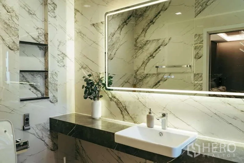 Detached House for sale in Sai Mai, Bangkok - Elegant bathroom with backlit mirror, stone countertop and marble‑patterned walls.